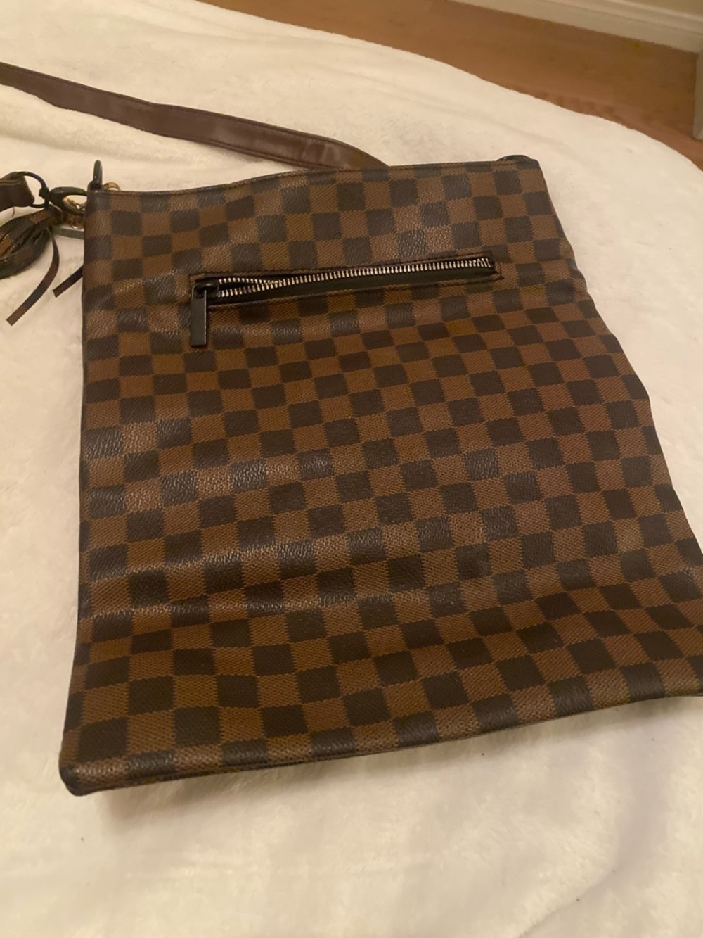 Brown Checkerboard Crossbody Bag has a slight slice on it